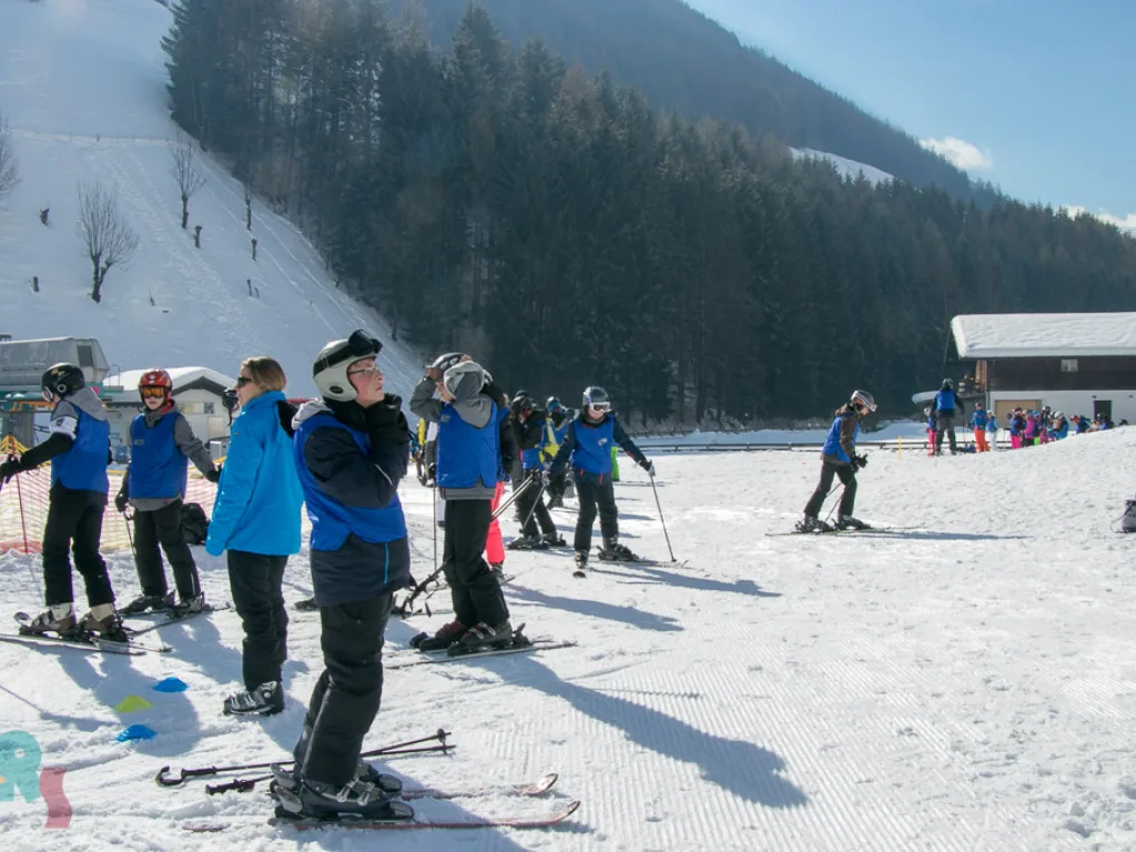 Skigruppe wartet am Rand der Übungswiese.